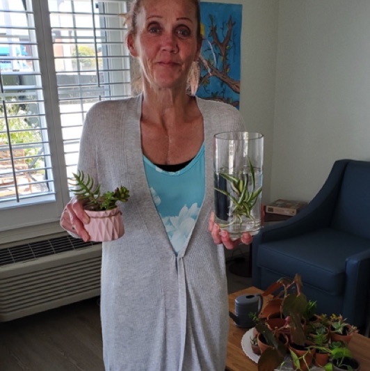 A Casa Buena resident admires her succulents.